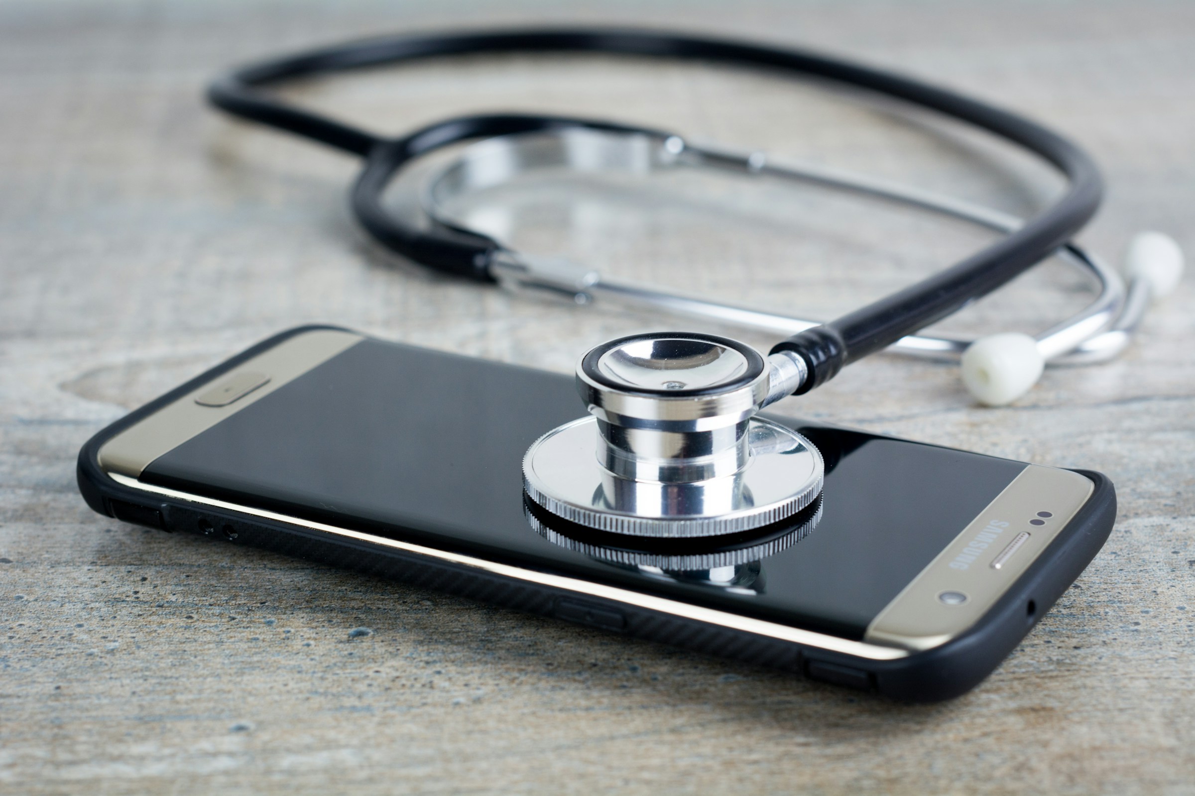 stethoscope on a phone - Healthcare Data Management 