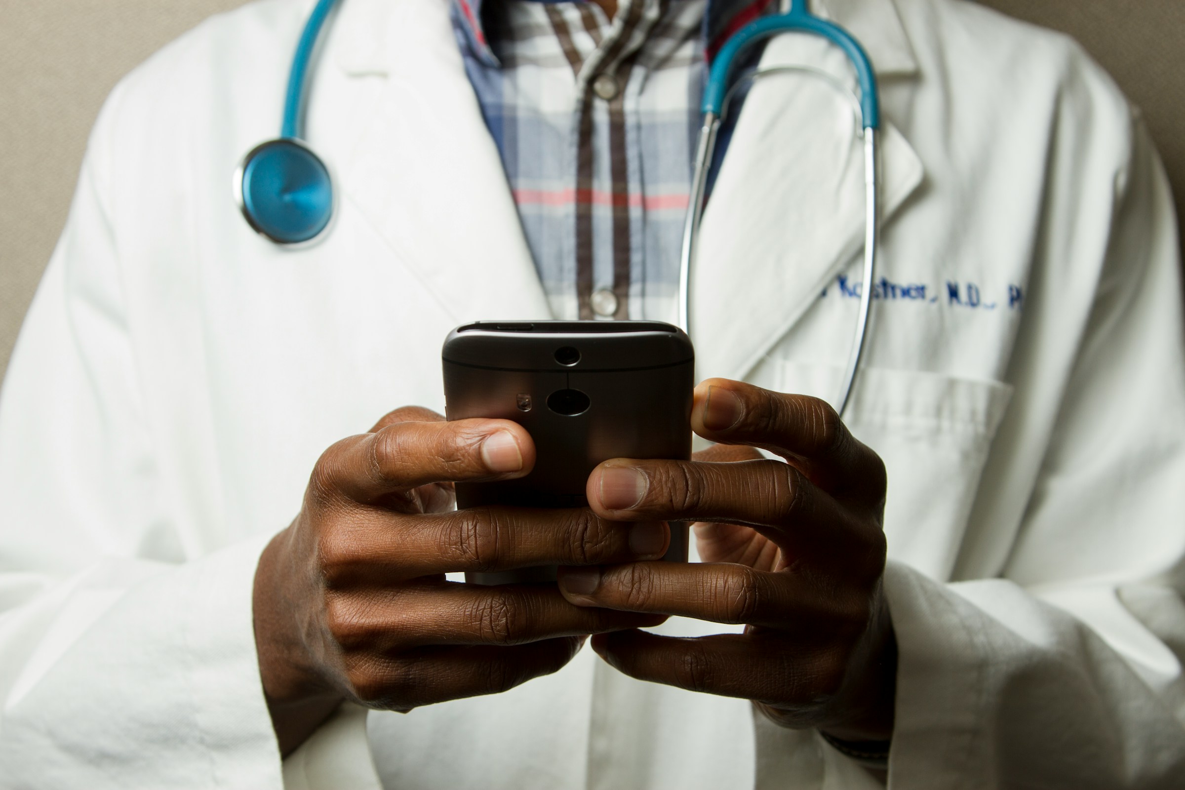 Doctor Using Mobile Phone - How Long Does Credentialing Take