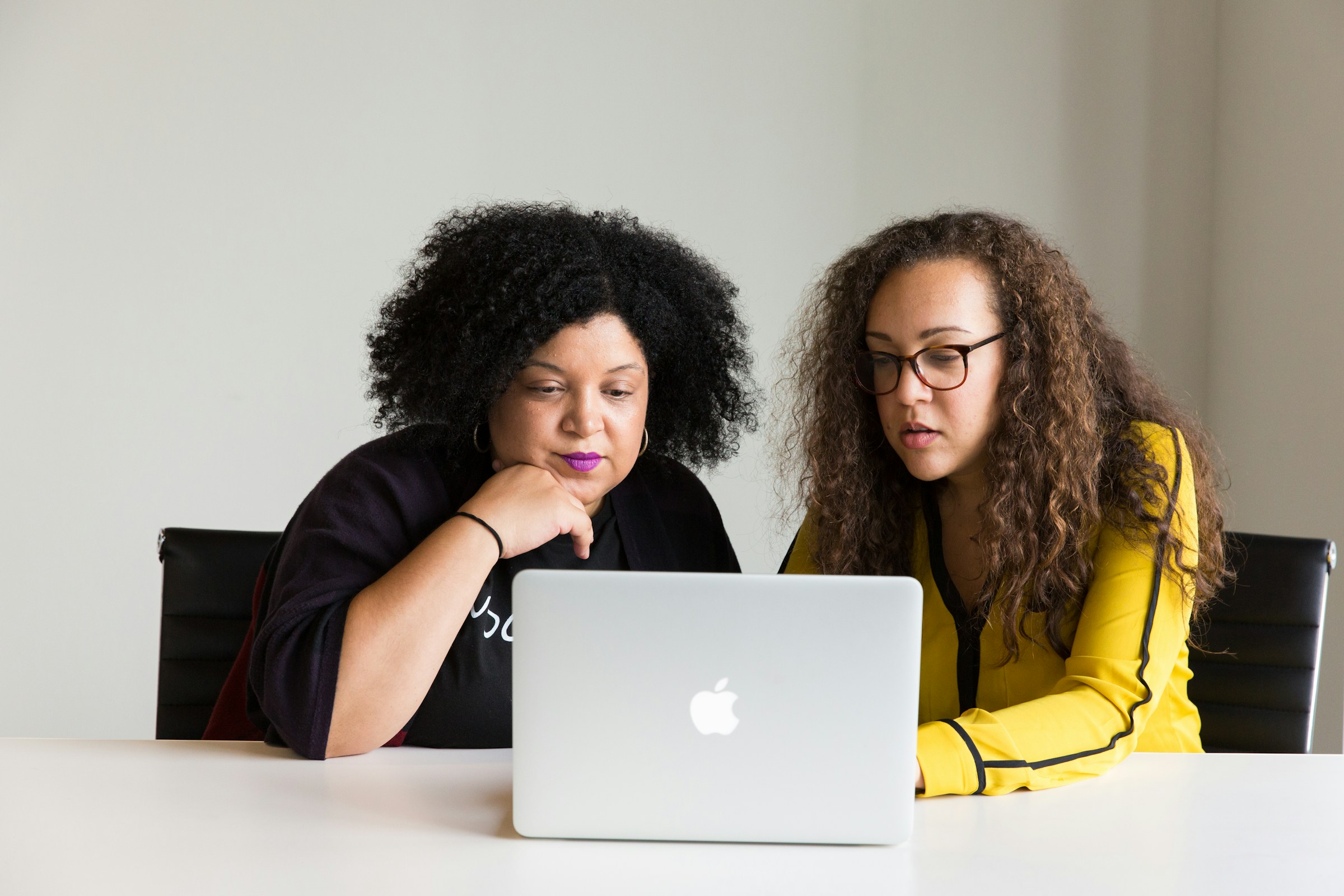 woman looking at a laptop - Scrum master roles and responsibilities 