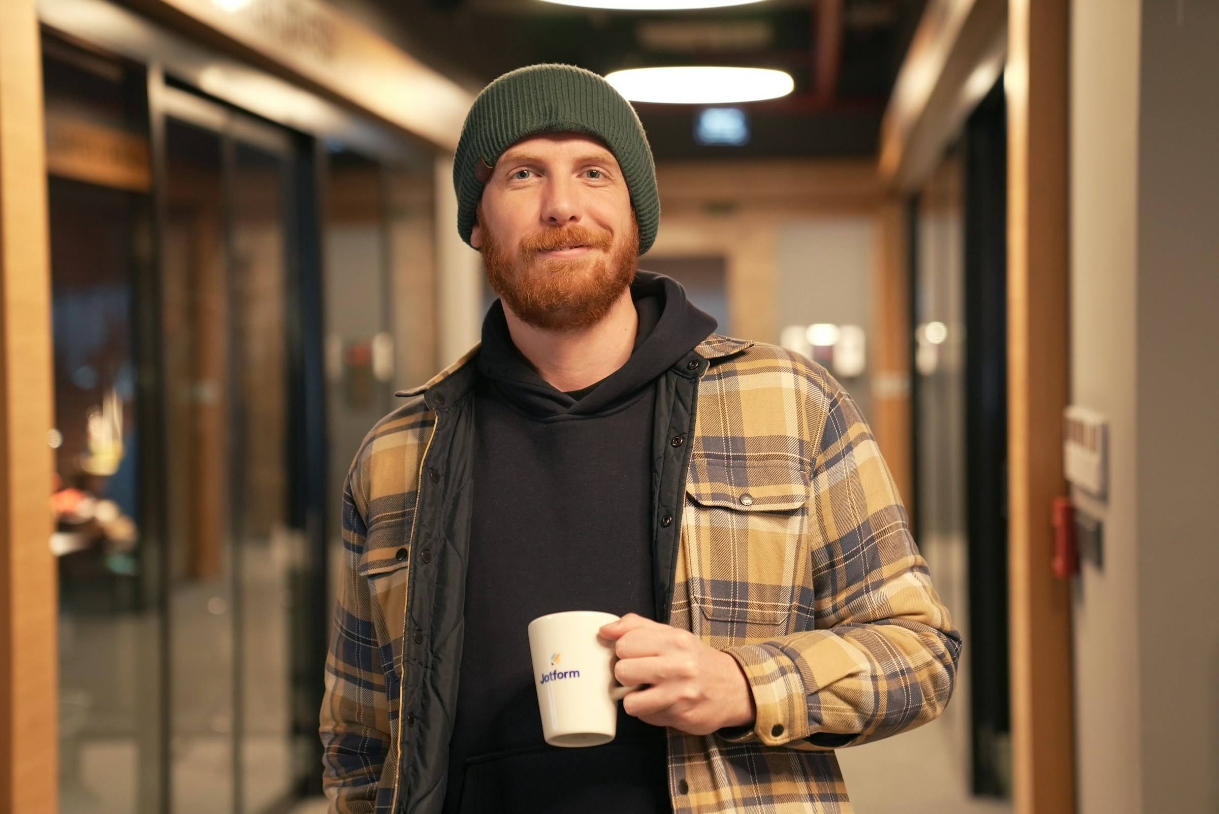 man holding a coffee cup - Data Architect Roles and Responsibilities 