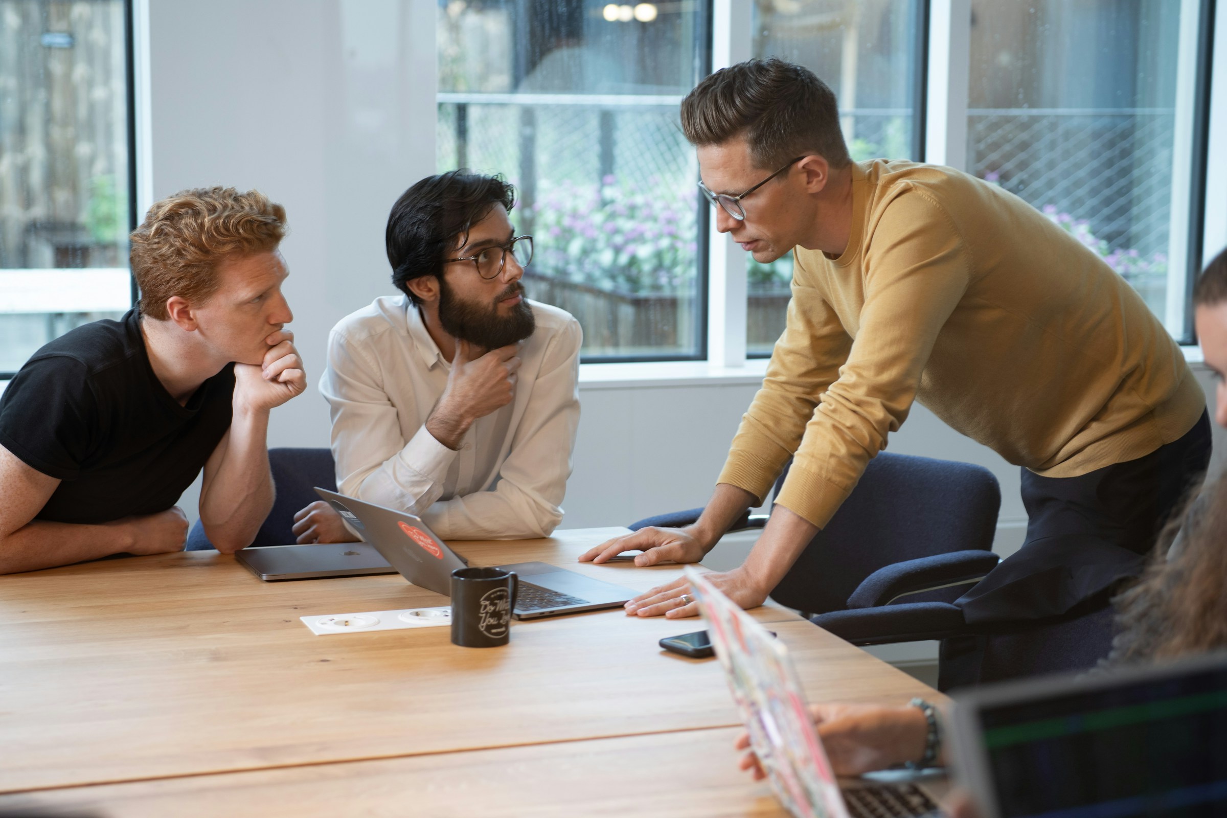 employees on a laptop - Scrum master roles and responsibilities 