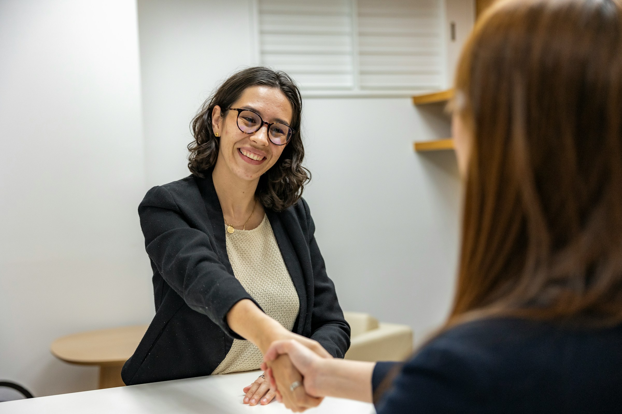 woman shaking hands - How to Hire A Project Manager