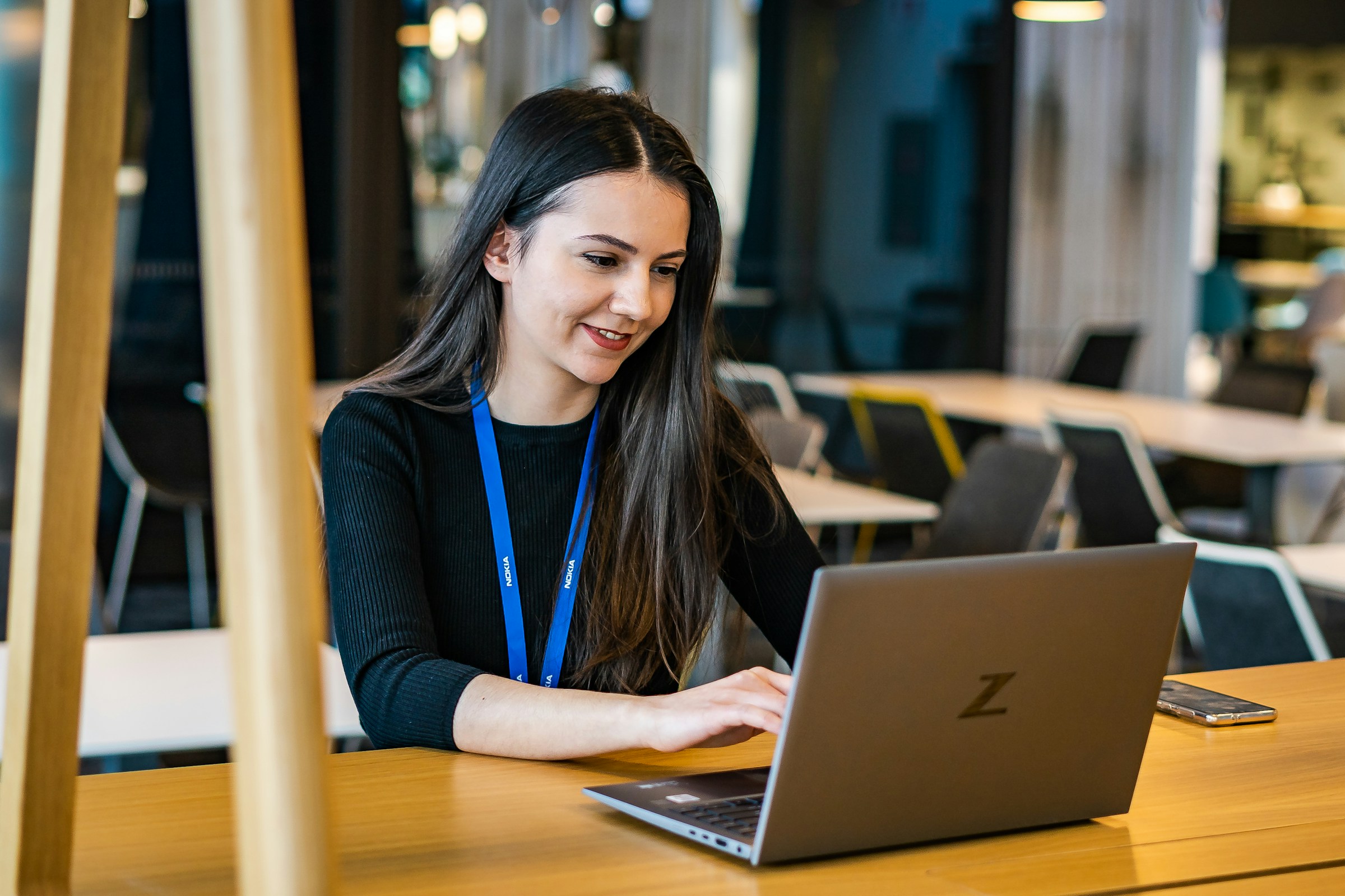 woman using a laptop - Project Executive vs Project Manager 