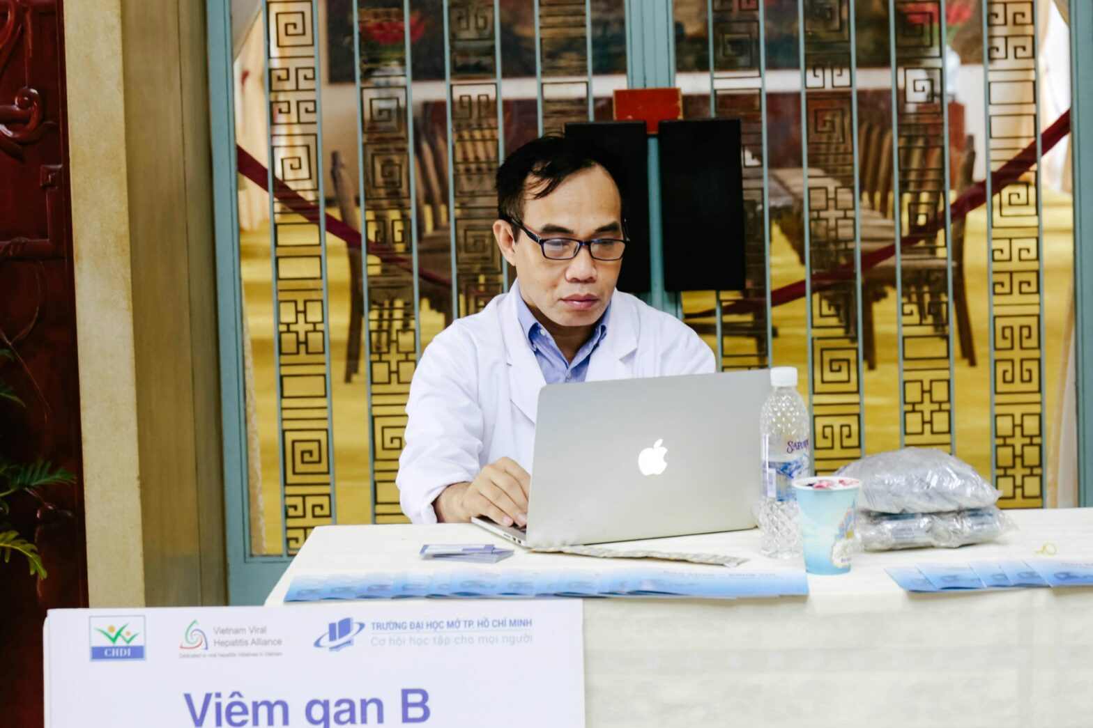Doctor Using Laptop - Physician Credentialing Services Cost